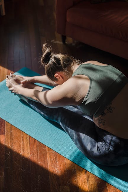 Person doing a morning stretch on a yoga mat in a cozy, sunlit room.